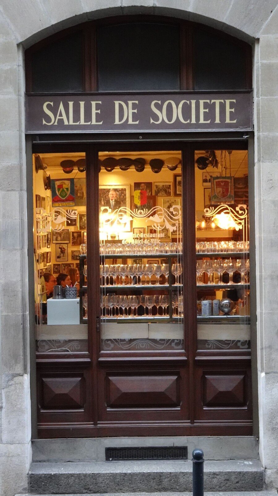 Davanti alla "Salle de Société", vetrina calda di bicchieri e ricordi.
