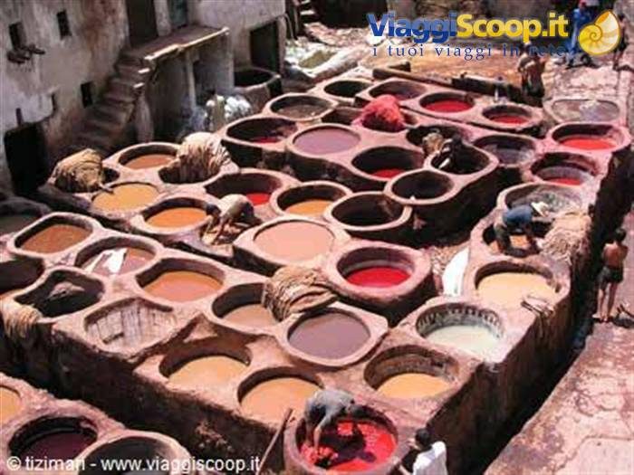 Operai lavorano nelle conche di pietra piene di coloranti delle concerie